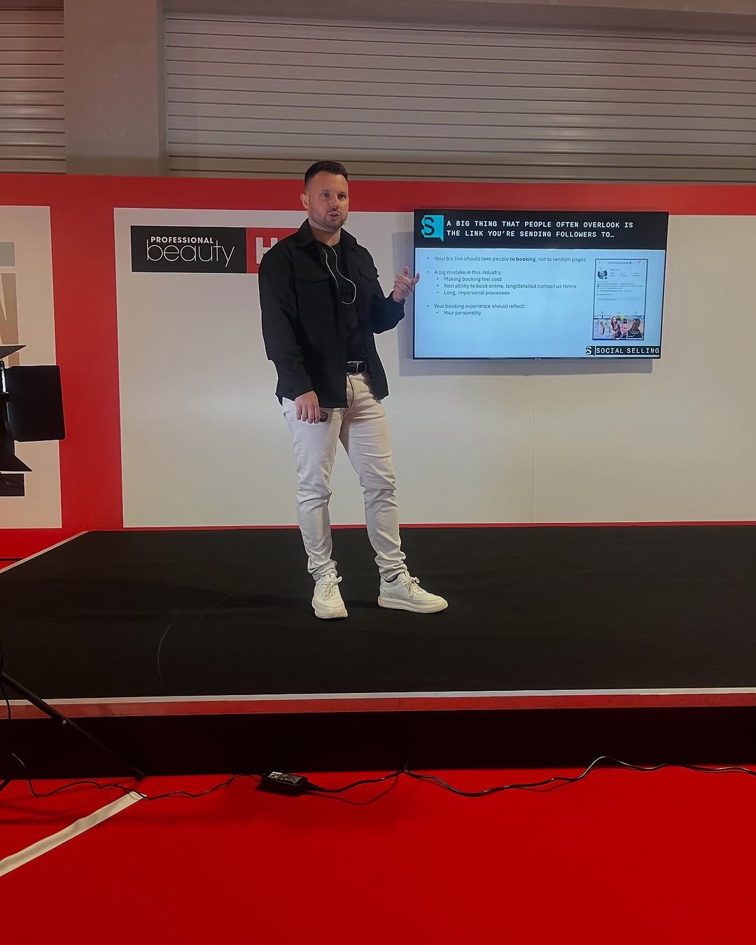 Chris Taylor speaking on stage at Professional Beauty
